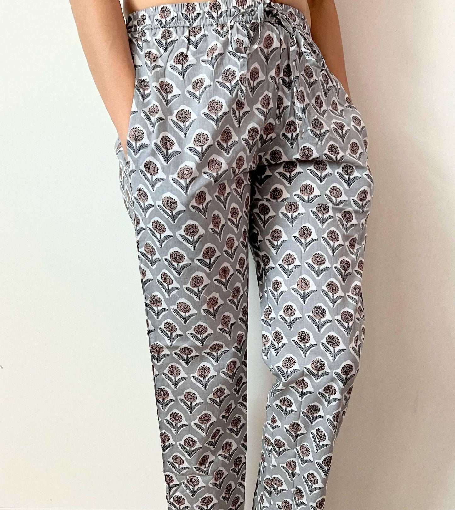 Preshrunk, 100% cotton.Adjustable waistband, big pockets. Comfy and breathable 100% cotton floral lounge and sleep pants with an adjustable waistband, deep side pockets, and a beautiful floral print.