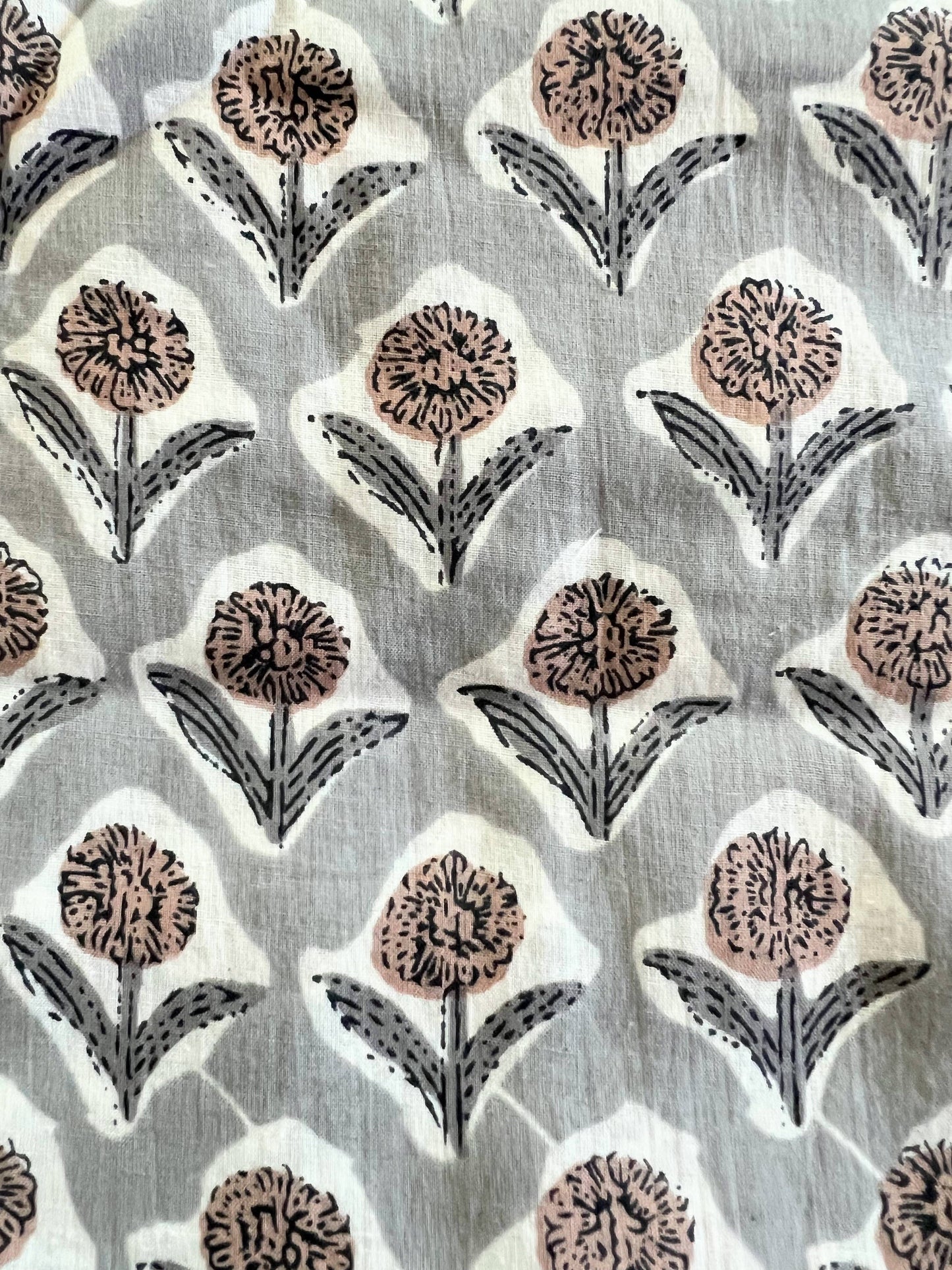 Light gray pants with a diamond pattern of cream pink blooms with smoke gray leaves - each flower sitting within a soft white block.