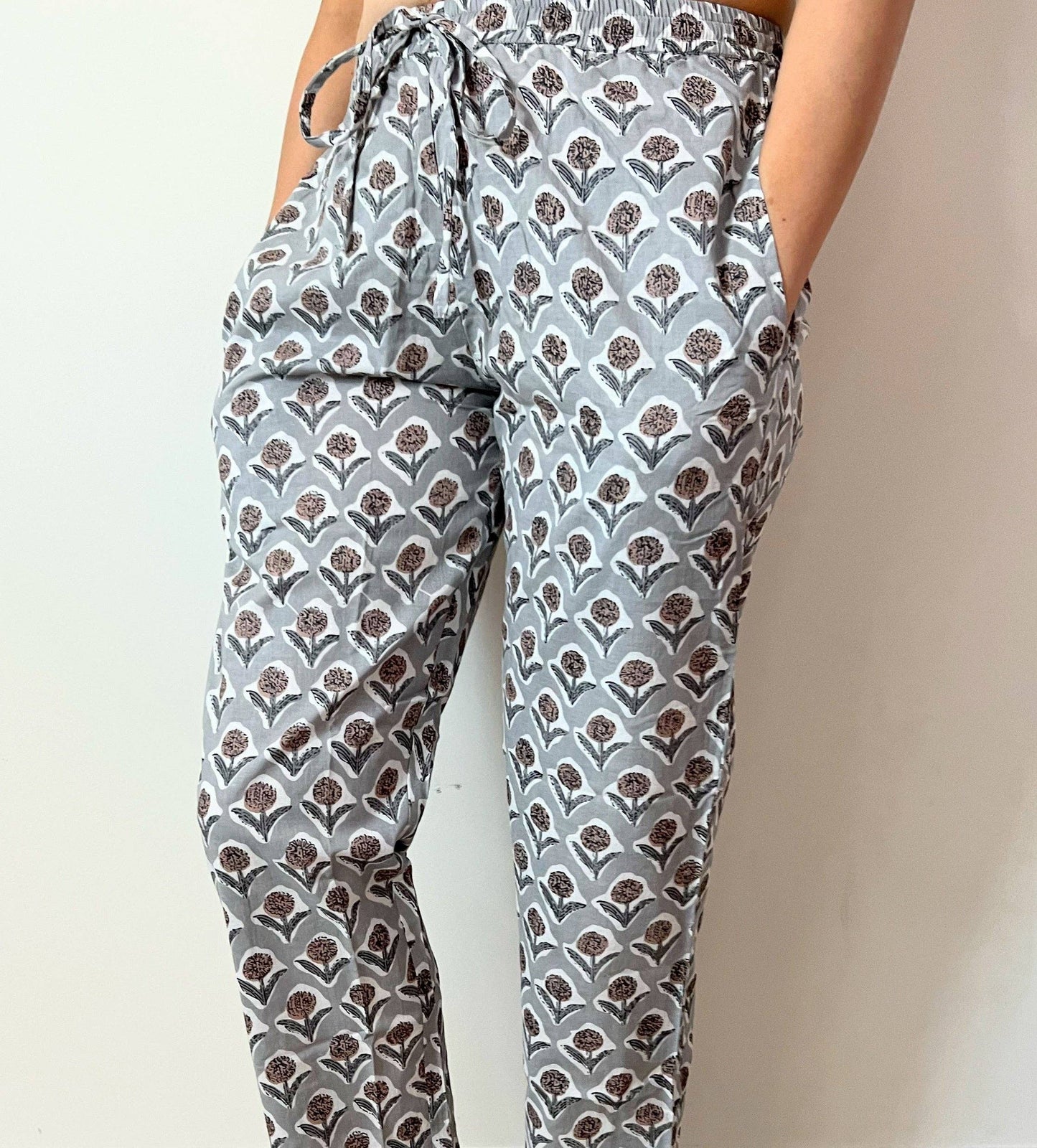 Preshrunk, 100% cotton.Adjustable waistband, big pockets. Comfy and breathable 100% cotton floral lounge and sleep pants with an adjustable waistband, deep side pockets, and a beautiful floral print.