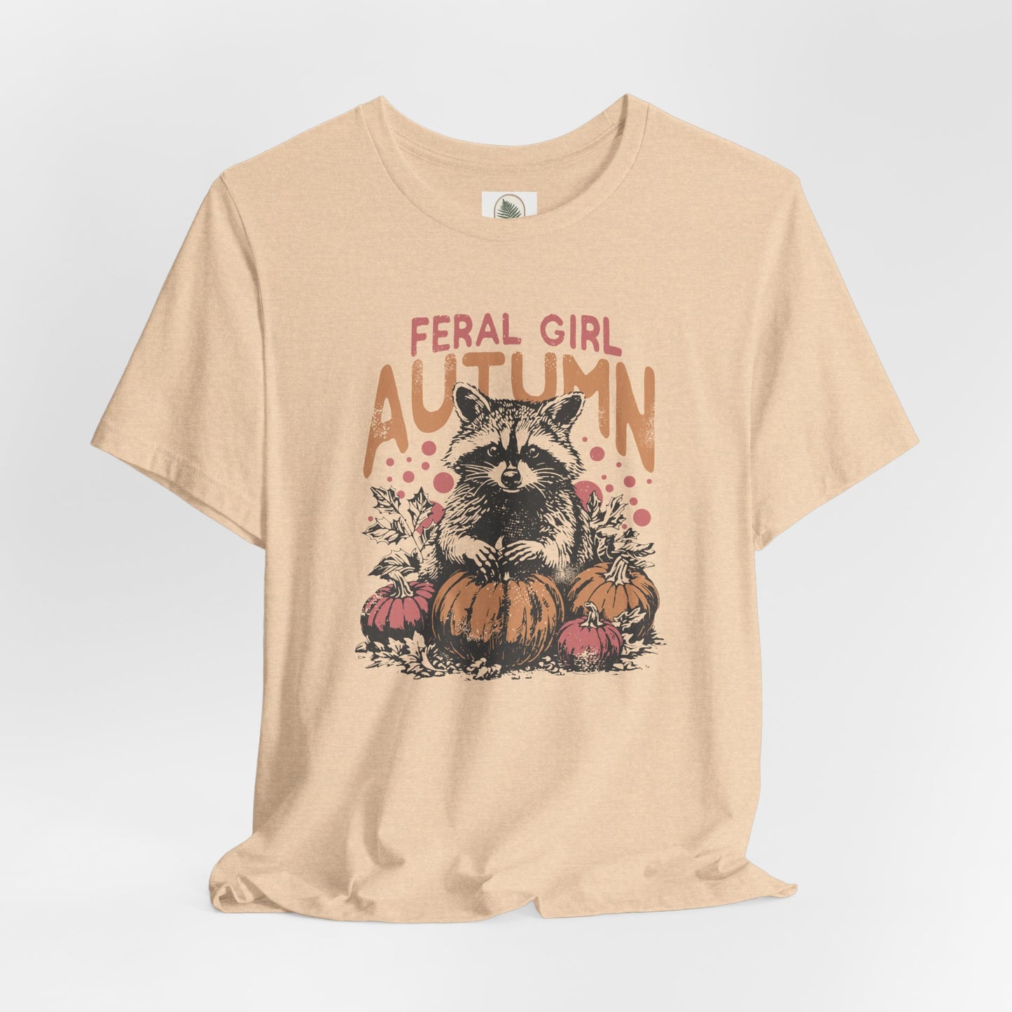 Feral Girl Autumn vintage-style unisex t-shirt featuring a raccoon with pumpkins, retro fall graphic, lightweight and comfortable cotton tee, perfect for pumpkin patch trips and cozy autumn outings, ethically made.