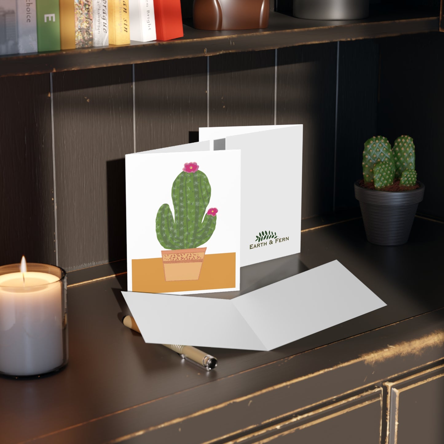 Colorful greeting card featuring a vibrant cactus in a decorative pot, perfect for plant lovers and desert-themed occasions. Inside of card is blank and the back shows the Earth and Fern logo.