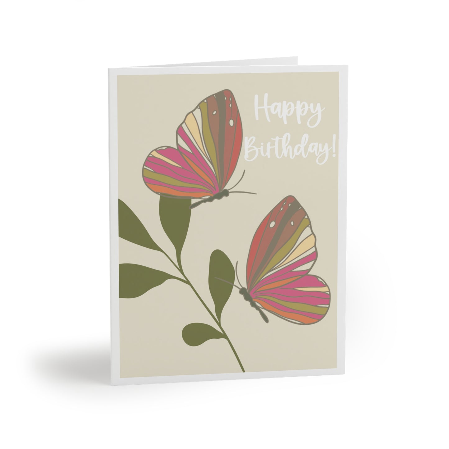 Greeting card with cream background and white border, featuring two butterflies in flight in hot pink, sage green, light yellow, lavender, and orange, flying around a darker sage leaf, with 'HAPPY BIRTHDAY' written on the front.