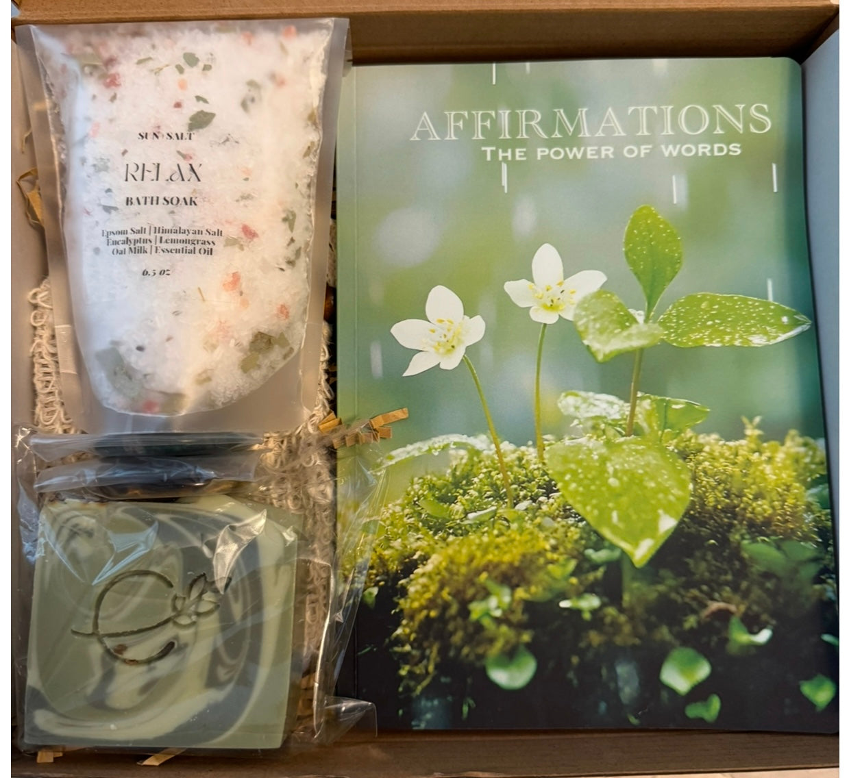 A Mind Body Spirit Deluxe box designed to support mental clarity, physical renewal, and spiritual calm with three curated self-care items. A guided affirmations journal for the mind, cleansing soap and bath soak for the body, and 2 worry stones to calm and ground the spirit.