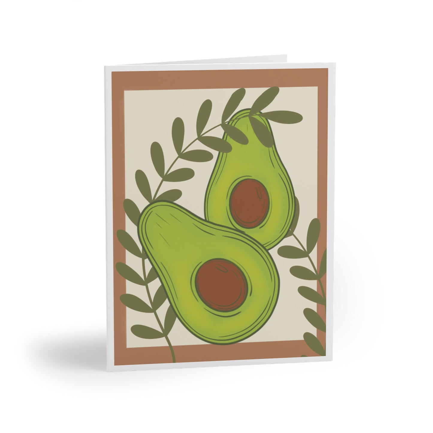 Greeting card with brown border and cream background featuring two green leaves and cut avocados