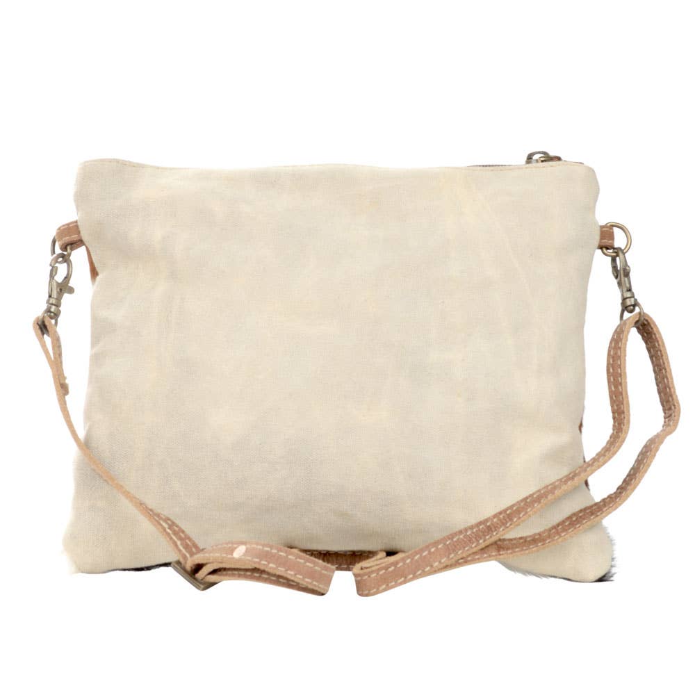Eco-friendly crossbody bag with cowhide accents, crafted from repurposed military tent canvas, on the back and featuring a bold buck design on canvas on the front. Durable and stylish, perfect for outdoor enthusiasts and sustainable fashion lovers