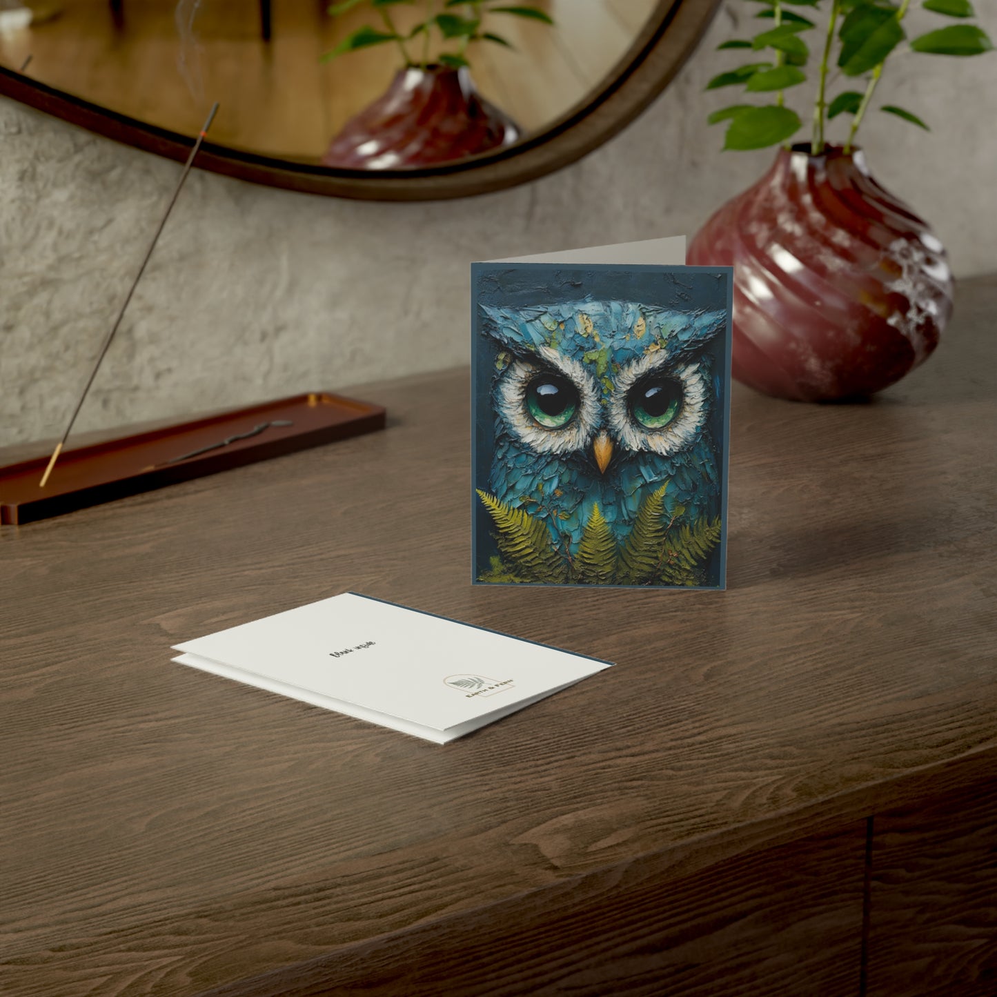 A beautifully painted greeting card featuring an oil and cold wax artwork of a soulful blue owl perched on a branch, perfect for any occasion.
