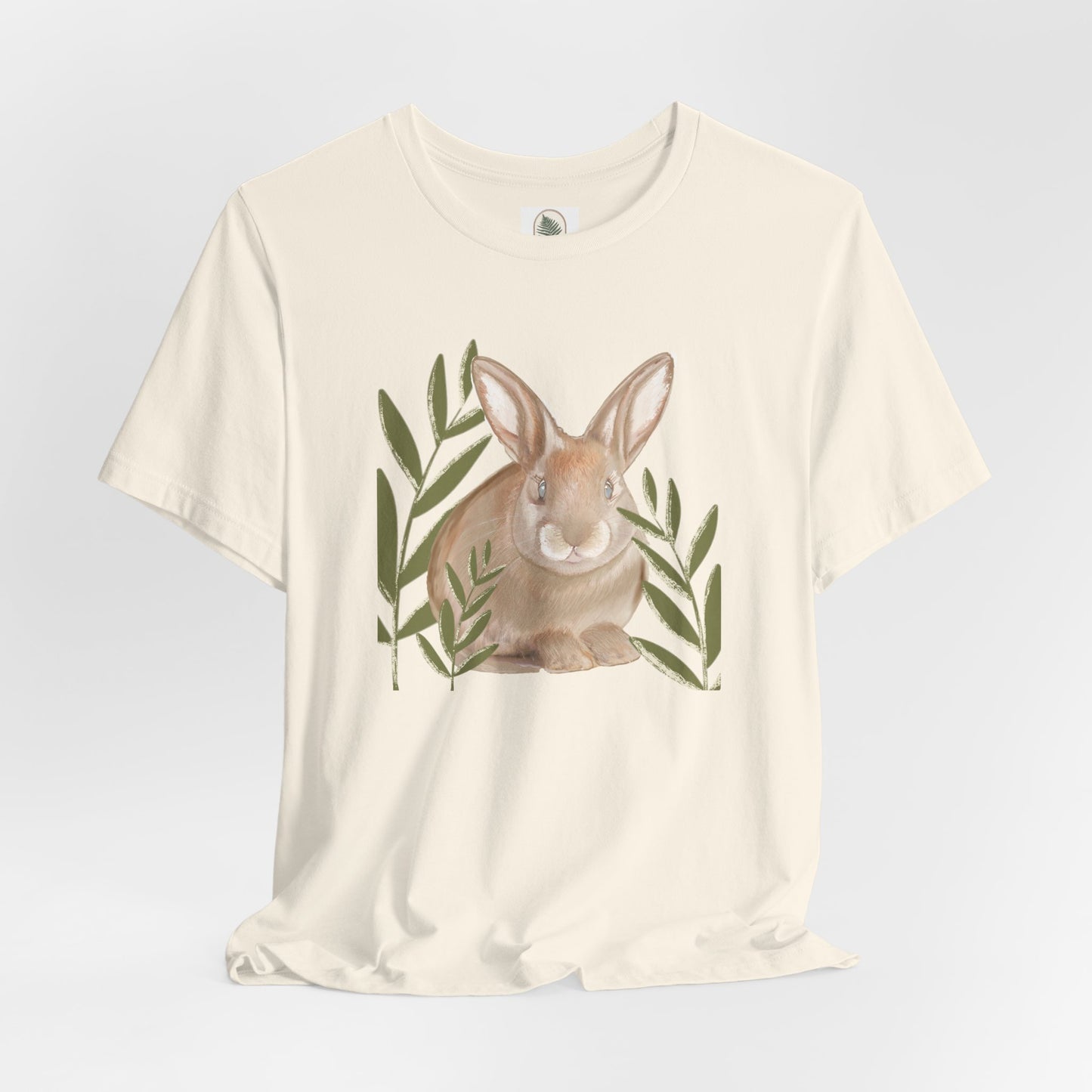 Custom artist sketched bunny graphic tee with playful bunny hiding between blades of grass, perfect for spring and Easter.