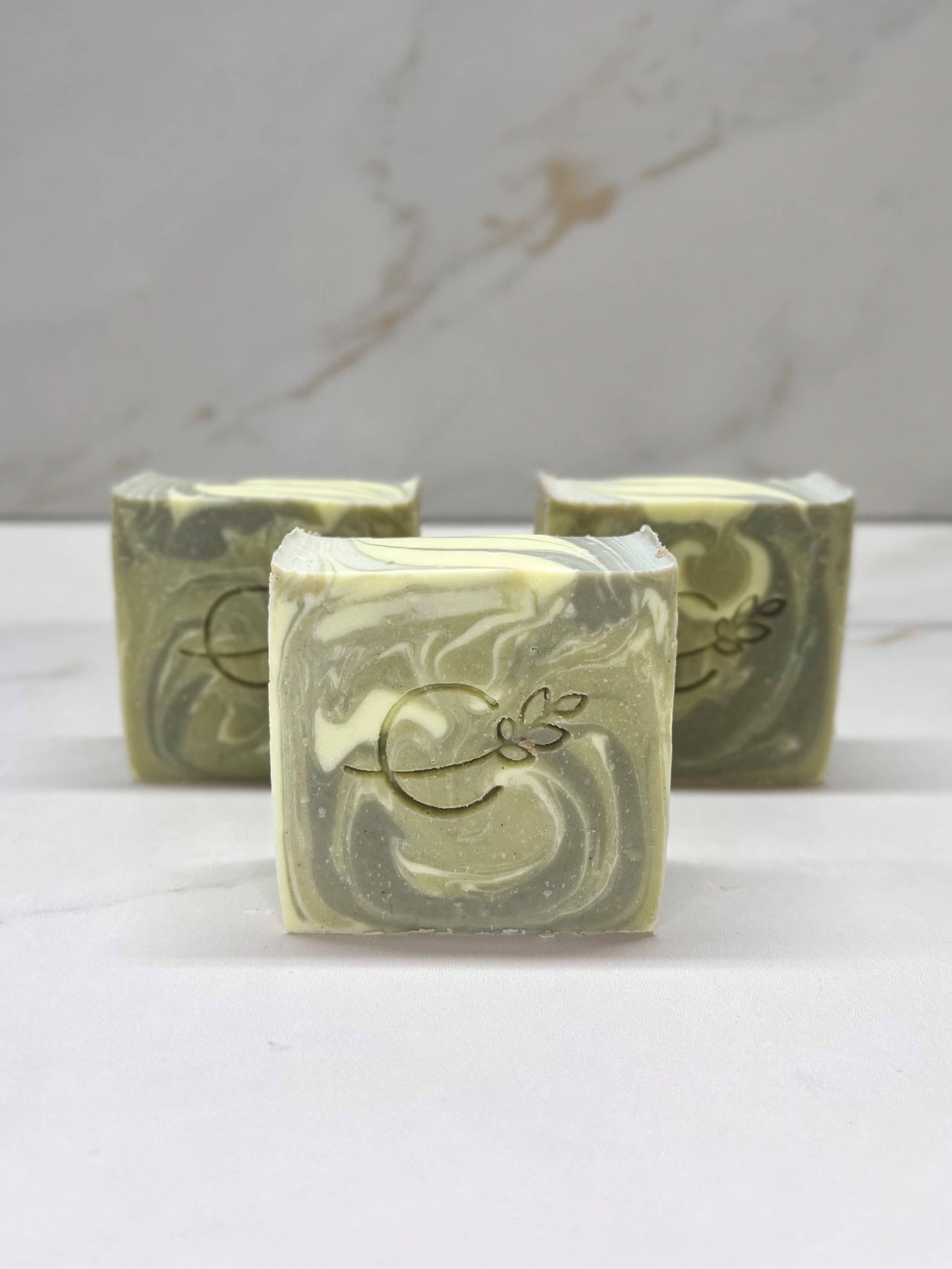 Luxury artisan soap with olive oil, coconut oil, and shea butter, handmade with natural ingredients, safe for all skin types, exfoliating and hydrating soap bars.