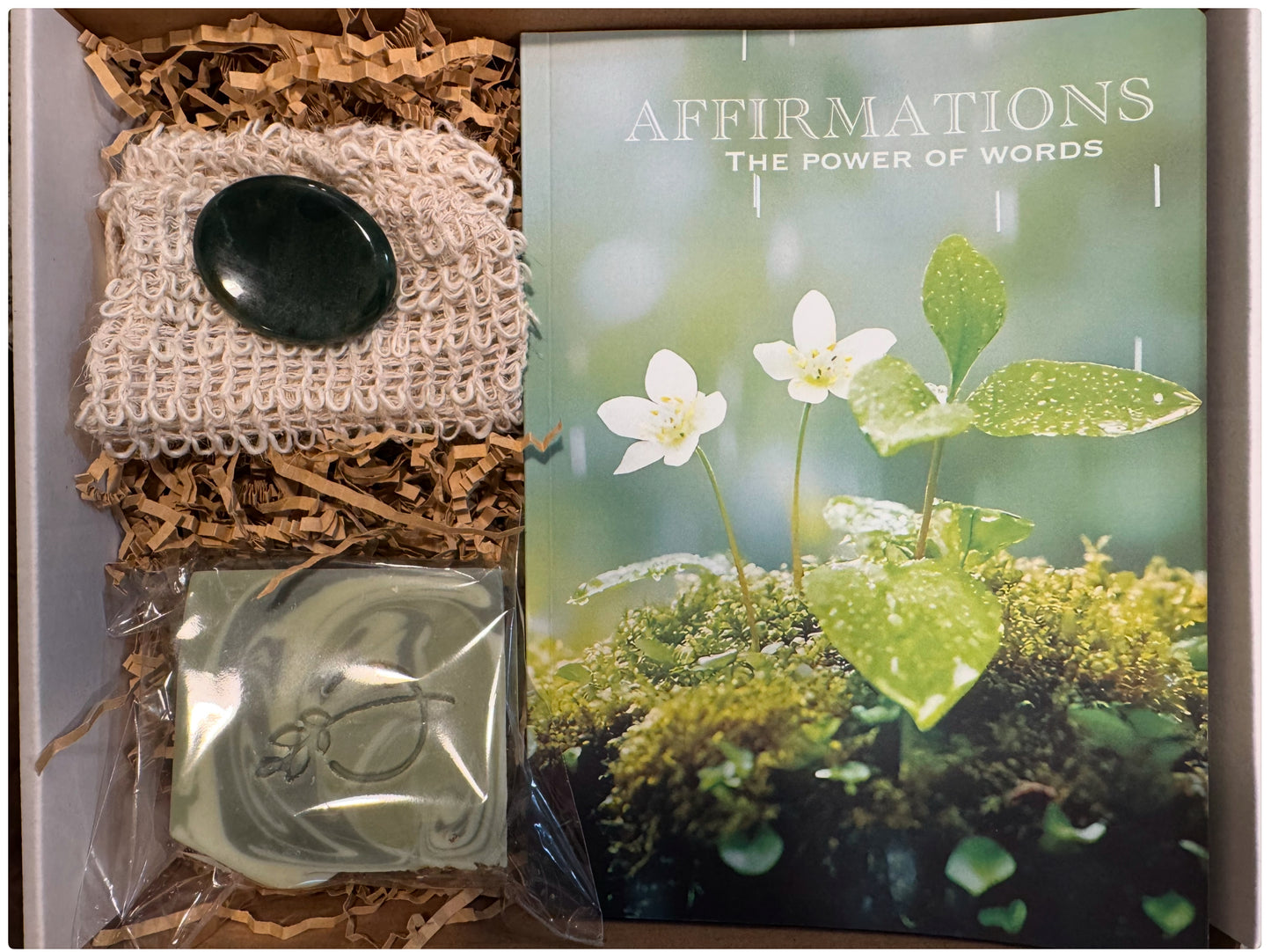 Mind Body Spirit box designed to support mental clarity, physical renewal, and spiritual calm with three curated self-care items. A guided affirmations journal for the mind, cleansing soap for the body, and a worry stone to calm the spirit.