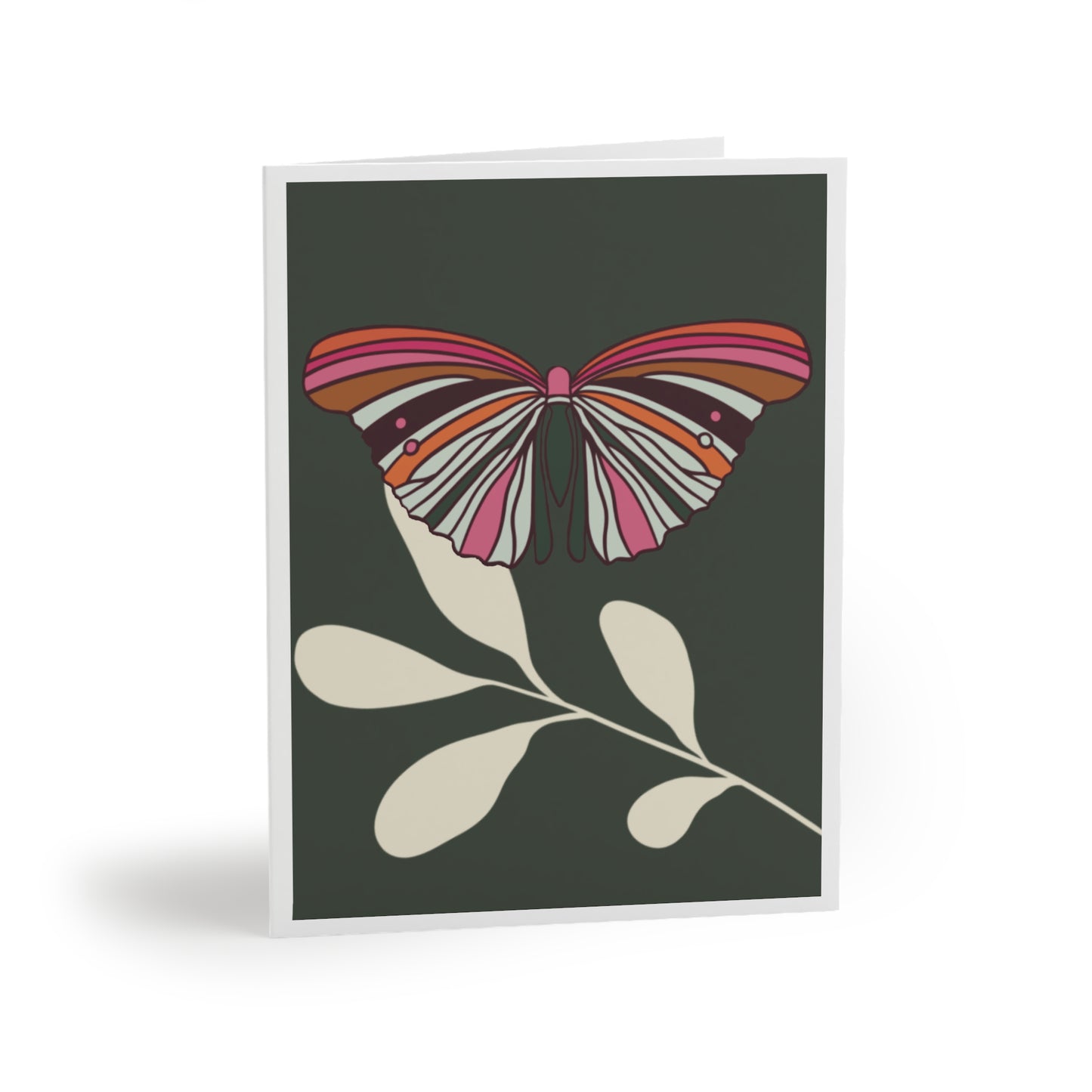 A sophisticated greeting card featuring a vibrant butterfly with wings spread, perched on a cream-colored leaf, set against a deep regency green background, perfect for any occasion. Image shows a Greeting Card with a single colorful butterfly with the colors orange, hot pink, cream and green colors. It sits on a single cream leaf with a forest green background with white border.
