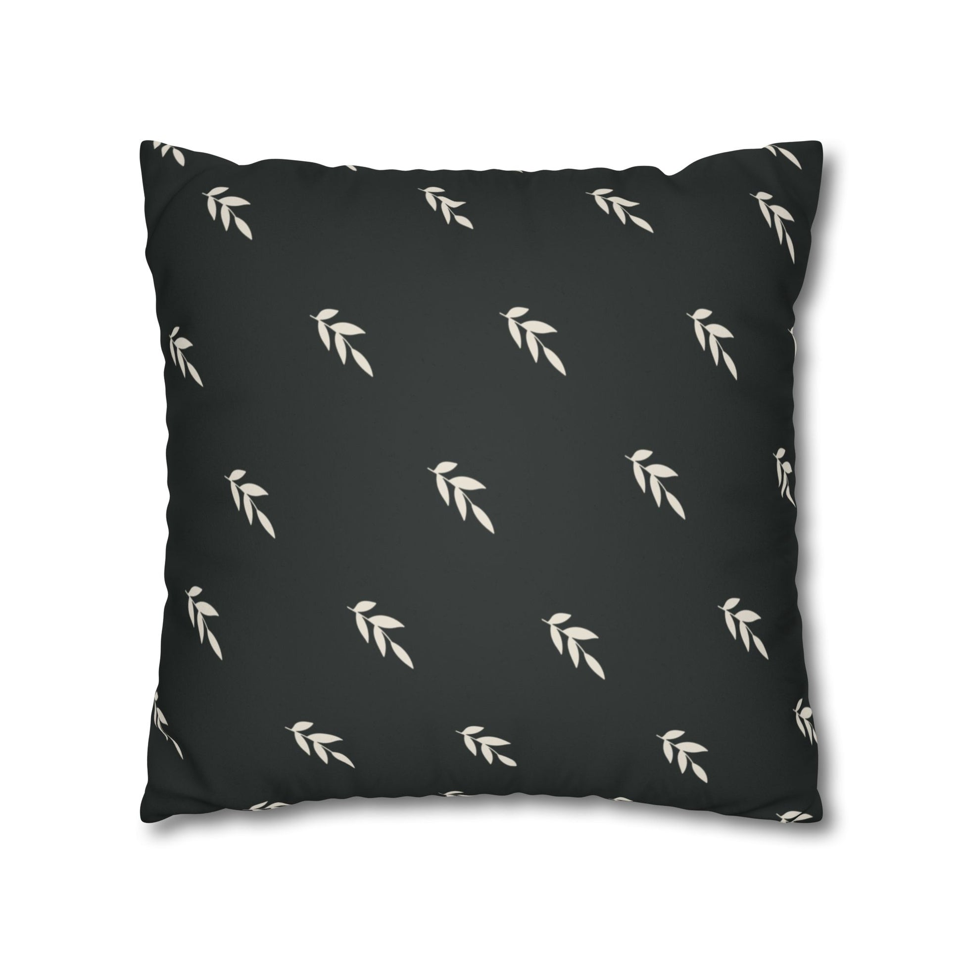 Abstract painted pillow cover featuring a sweet green bird with soulful eyes nestled in a fern leaf. The back of pillow is black with a complementary repeating motif of  tiny crream covered leaves