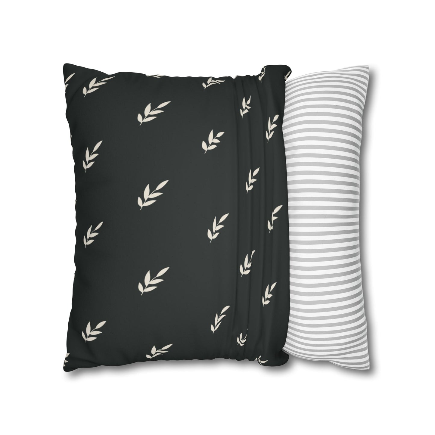 Abstract painted pillow cover featuring a sweet green bird with soulful eyes nestled in a fern leaf. The back of pillow is black with a complementary repeating motif of  tiny crream covered leaves