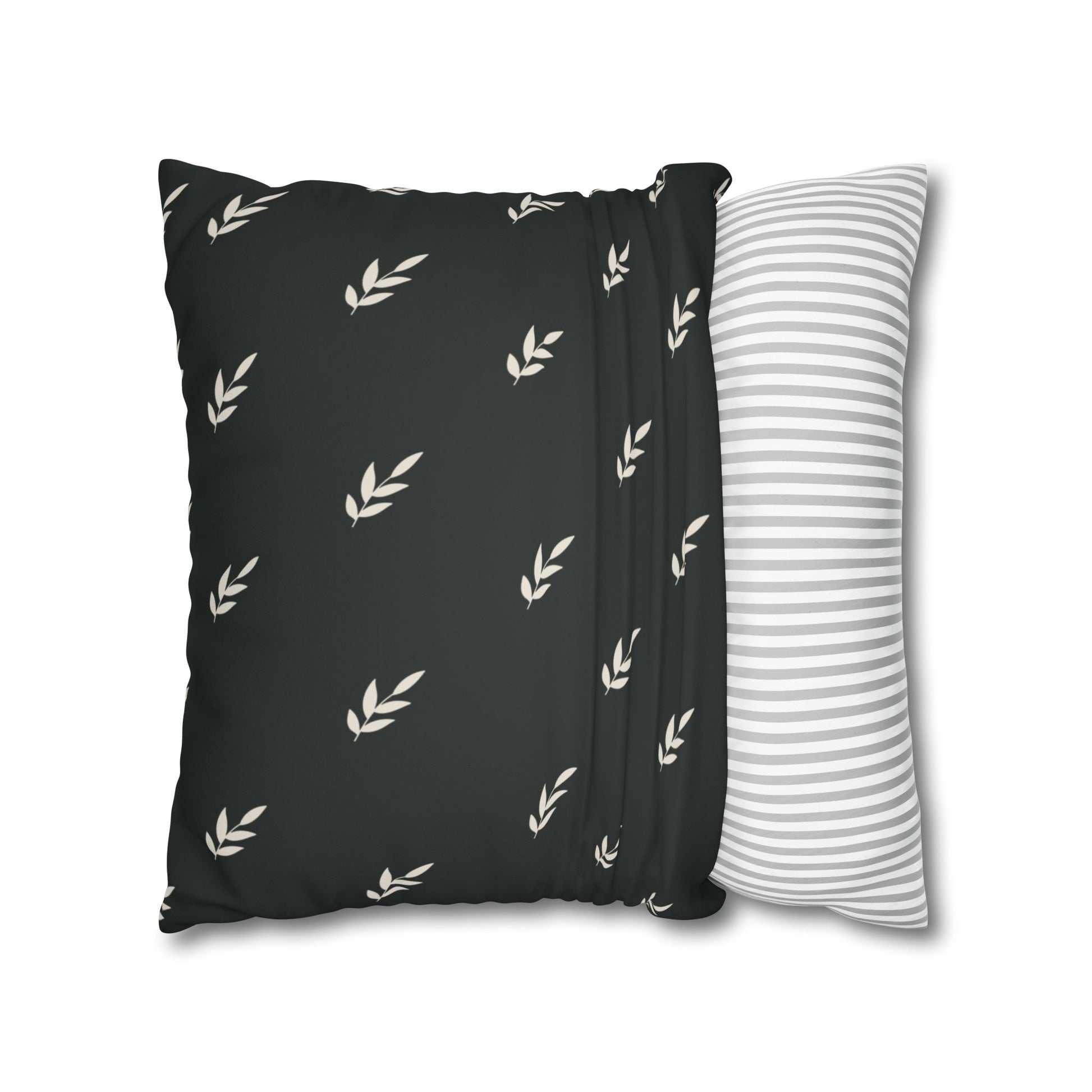 Abstract painted pillow cover featuring a sweet green bird with soulful eyes nestled in a fern leaf. The back of pillow is black with a complementary repeating motif of  tiny crream covered leaves