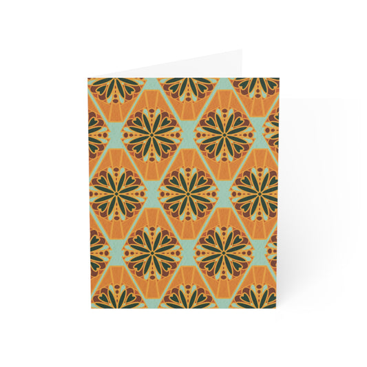 Front of a greeting card featuring a colorful millefiori design, showcasing a repeating pattern of vibrant flower tiles in various hues. Millefiori, an Italian term meaning 'a thousand flowers,' creates a stunning floral mosaic effect. The inside of the card is blank, perfect for personal messages, with the back featuring the text 'Blank inside' and the company logo. Ideal for sending floral greetings, birthday wishes, or any special occasion.