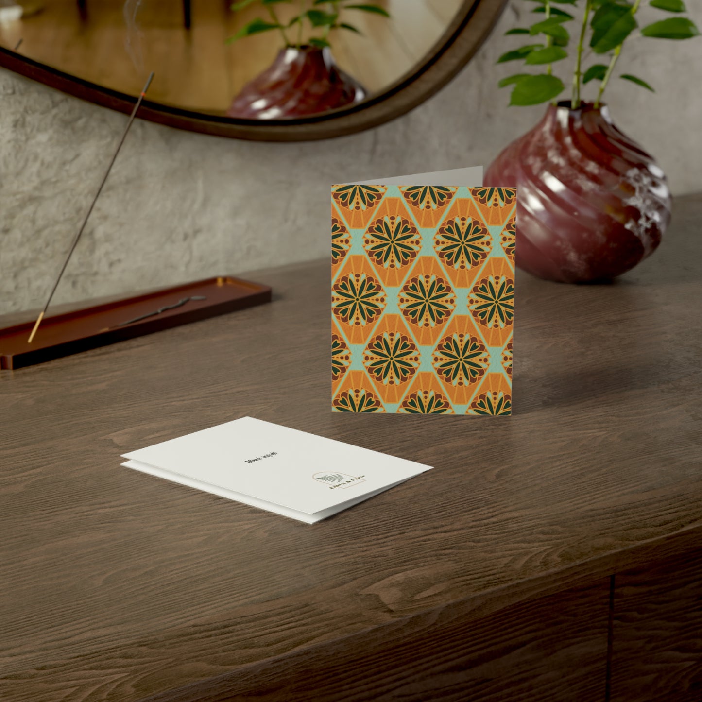 Front of a greeting card featuring a colorful millefiori design, showcasing a repeating pattern of vibrant flower tiles in various hues. Millefiori, an Italian term meaning 'a thousand flowers,' creates a stunning floral mosaic effect. The inside of the card is blank, perfect for personal messages, with the back featuring the text 'Blank inside' and the company logo. Ideal for sending floral greetings, birthday wishes, or any special occasion