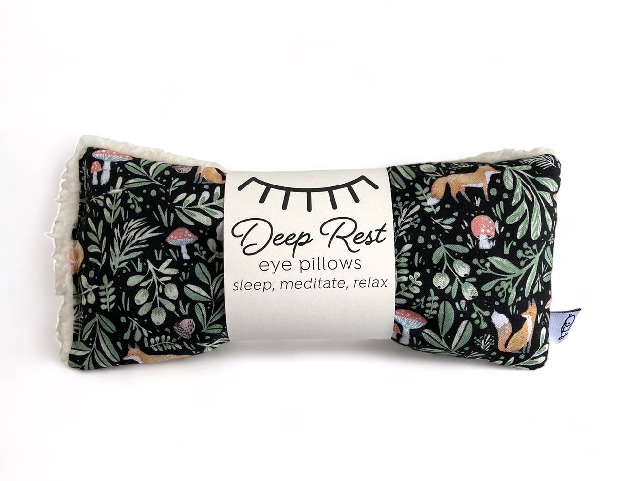 Black with green woodsy leaves with little foxes and mushrooms. Deep Rest Eye Pillow with rice filling for relaxation, stress relief, and improved sleep, featuring a cotton front and soft minky backing, ideal for heating or cooling