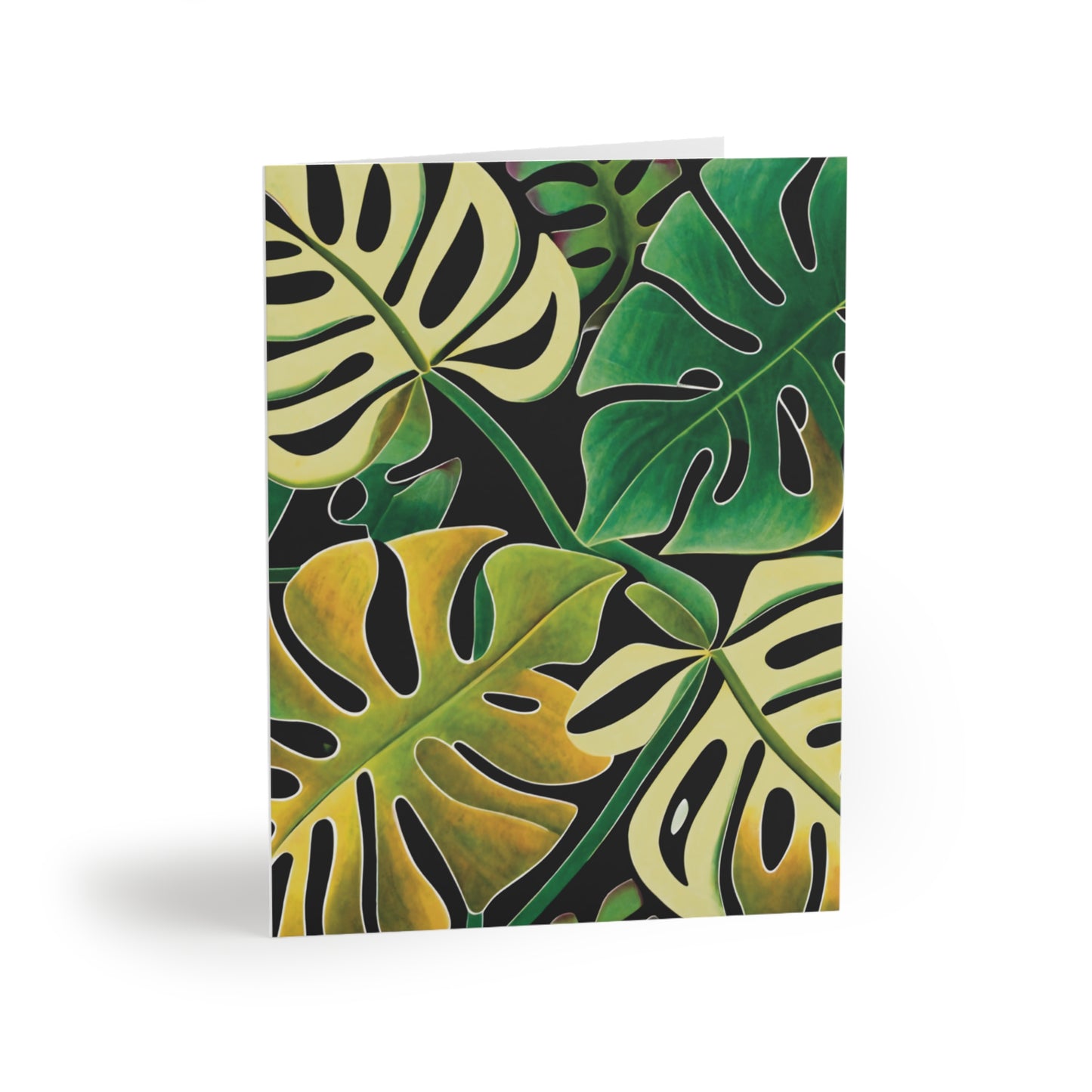Front of a greeting card featuring a design of four Monstera leaves in various shades of green, arranged in a stylish quad layout. The vibrant green tones of the Monstera leaves create a fresh, tropical look, perfect for plant lovers or nature-themed occasions. The inside of the card is blank for personal messages, with the back displaying the text 'Blank inside' and the company logo