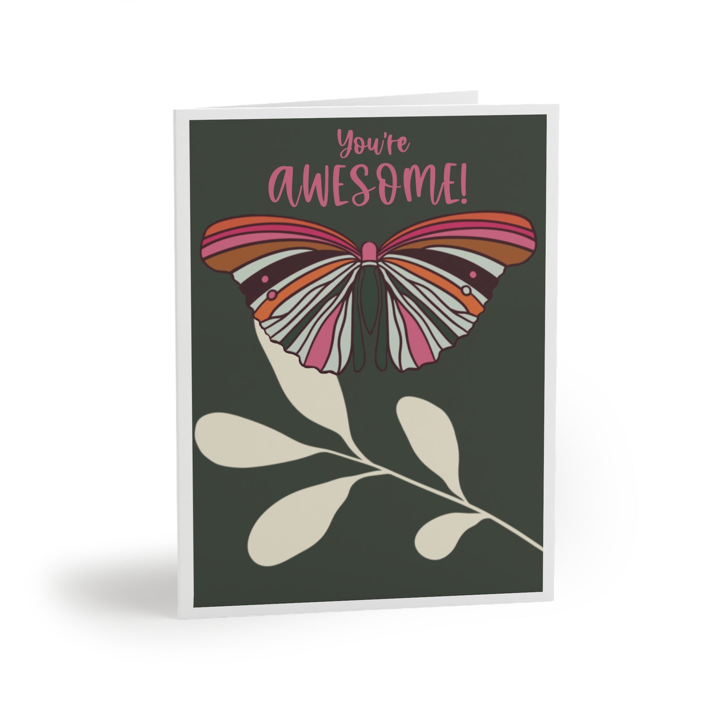 Image shows a Greeting Card with  a single colorful butterfly with the colors pink, orange, hot pink, cream and brigands colors. It sits on a single cream leaf with a forest green background with white border. The words “You’re Awesome!”  are at the top of the card in hot pink.