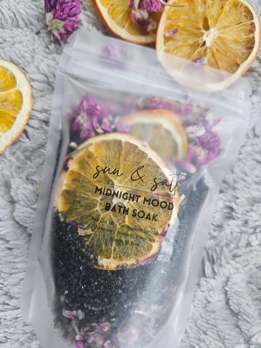 Handmade Midnight Mood Bath Soak with Black Lava Salt, Pink Himalayan Salt, Chamomile, Lavender, Amaranth, Orange Slices, and an essential oil blend for a calming, mood-enhancing bath experience.