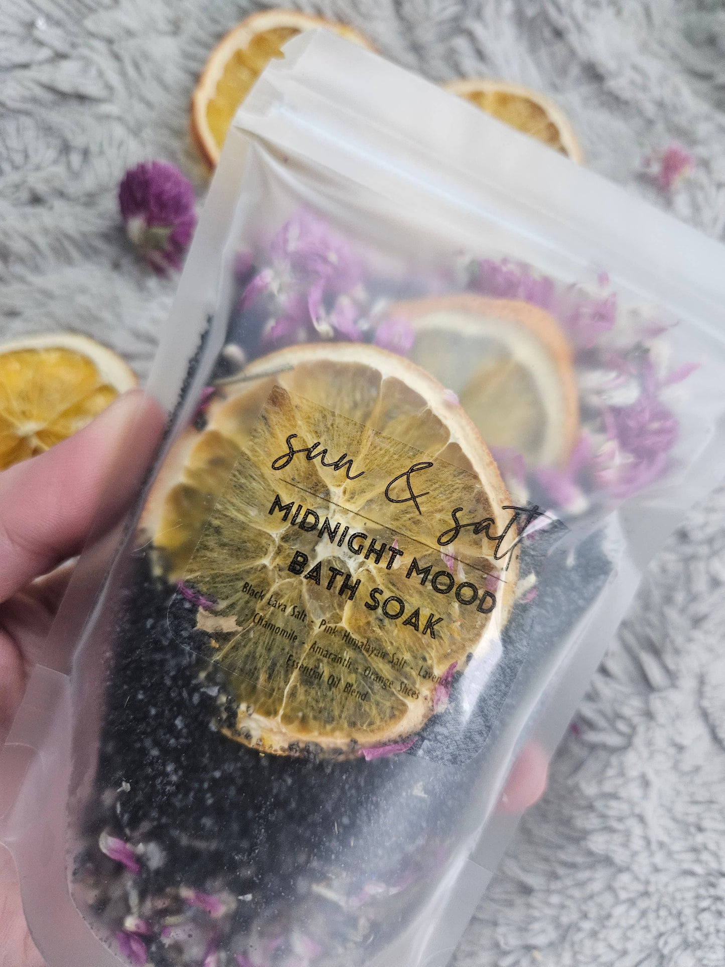 Handmade Midnight Mood Bath Soak with Black Lava Salt, Pink Himalayan Salt, Chamomile, Lavender, Amaranth, Orange Slices, and an essential oil blend for a calming, mood-enhancing bath experience.
