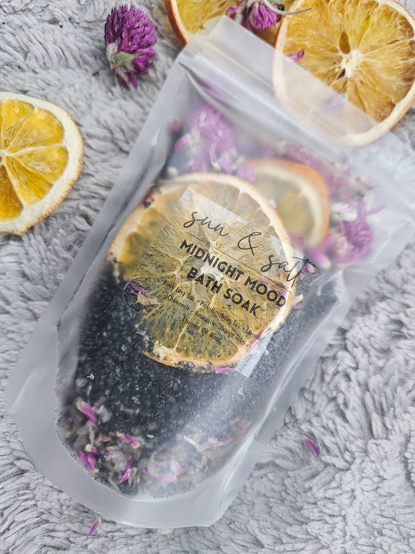 Handmade Midnight Mood Bath Soak with Black Lava Salt, Pink Himalayan Salt, Chamomile, Lavender, Amaranth, Orange Slices, and an essential oil blend for a calming, mood-enhancing bath experience.