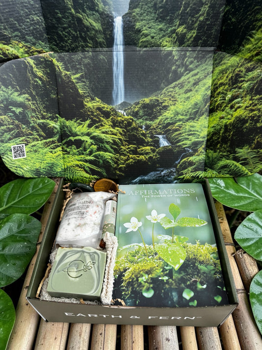 Open box with affirmations guided journal, invigorating Eucalyptus Soap, Relaxing bath rock, Nourishing Mint Lip balm,2 worry stones, with complimentary sisal soap bag.
