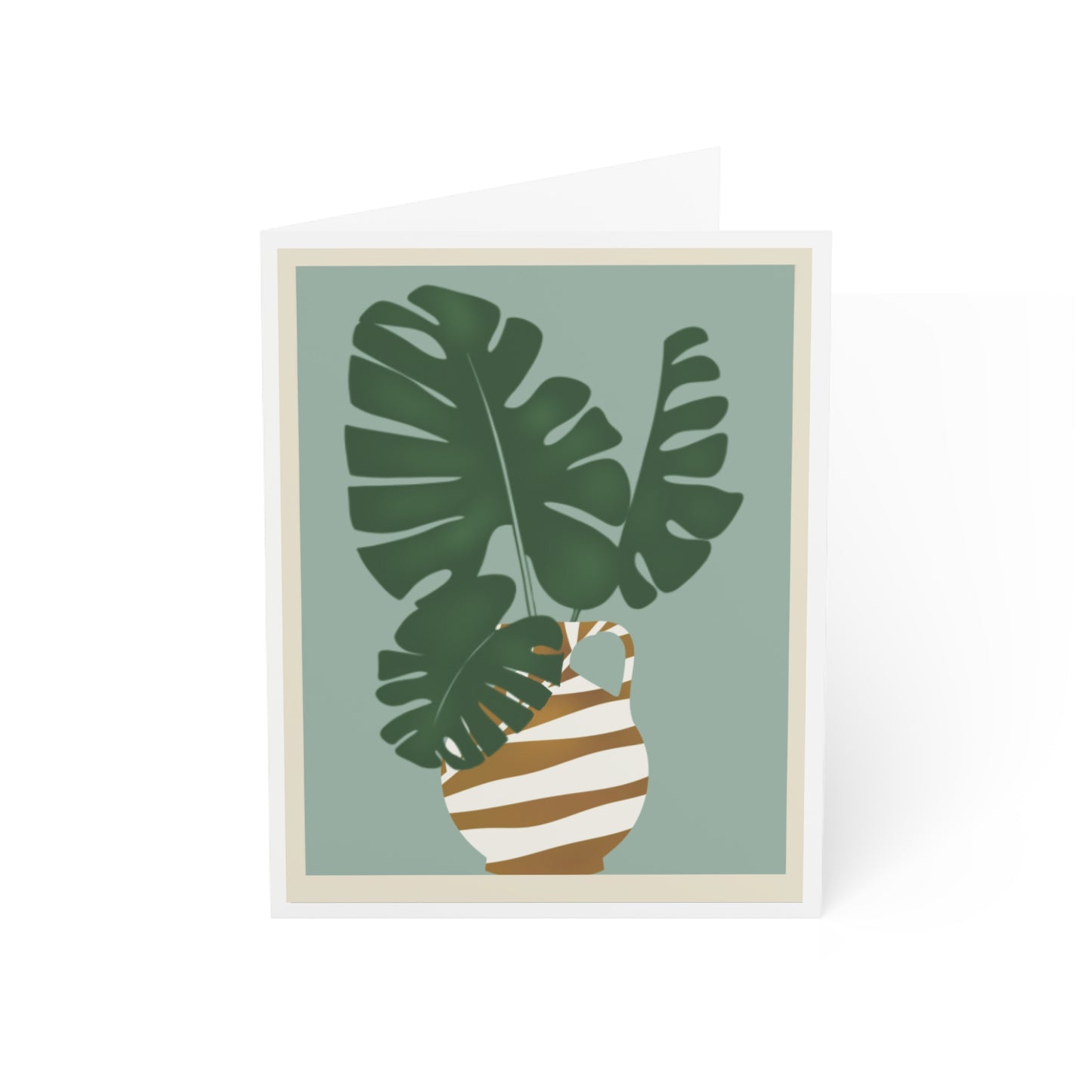 Front of a greeting card featuring a pastel aqua background with a Monstera plant displayed in a gold and white striped vase, with the vase drawn in an ancient Egyptian style. The card is framed by a white border around the perimeter, creating a clean, elegant look. The inside of the card is blank, perfect for personal messages, and the back includes the text 'Blank inside' along with the company logo. Ideal for sending nature-inspired greetings, home decor enthusiasts, or any special occasion.
