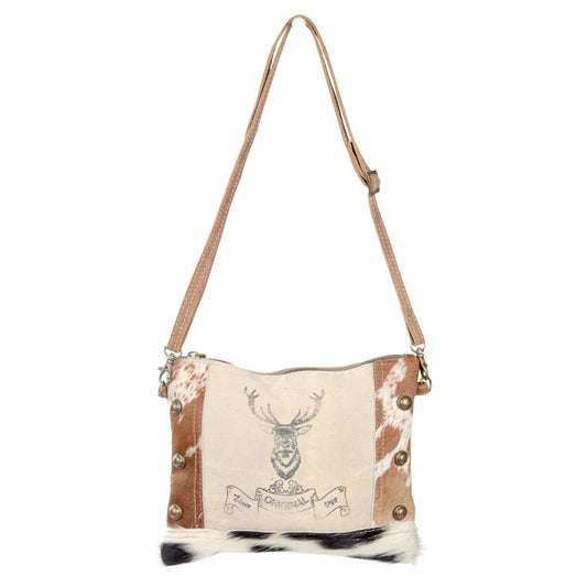 Eco-friendly crossbody bag with cowhide accents, tan and white on top80%, black and white on the bottom 20 %, crafted from repurposed military tent canvas, featuring a bold buck design on canvas on the front. Durable and stylish, perfect for outdoor enthusiasts and sustainable fashion lovers