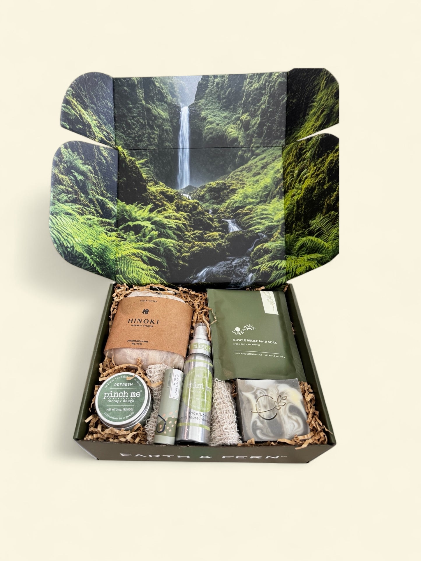 Open Box with Hinoki flakes and muscle bath soak, Aromatherapy spray, therapy dough, mint lip balm and cedarwood pine soap, with a complimentary sisal soap bag.