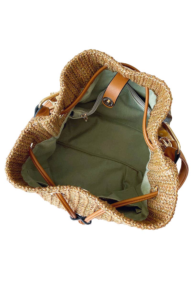 Boho-style woven rattan bucket bag with bamboo top handle and crossbody strap, featuring drawstring closure and inner compartments