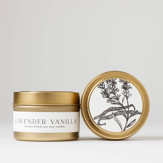 Hand-poured 4 oz. soy candle from the Flora Collection with lavender, vanilla, cedarwood, and orange zest, in a clear glass jar with a gold steel lid.